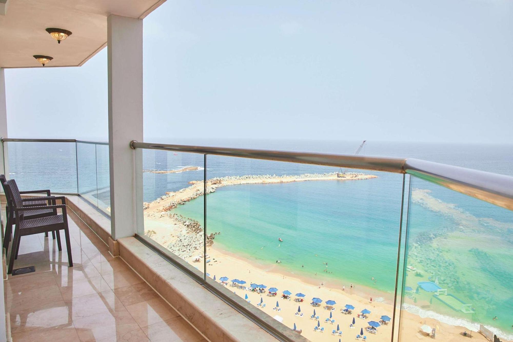 Hilton Alexandria Corniche Hotel Exterior photo View of the beach from the balcony of a suite